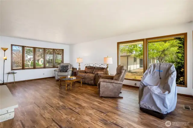 The living room is spacious enough to put a large sectional, area rug, and large TV as you cozy up to the log fire and invite guests to hang out with you.
