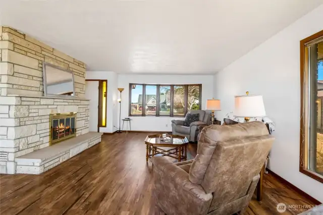 Another view of the living room and cozy fireplace.  The narrow yellow window is right by the French front doors.