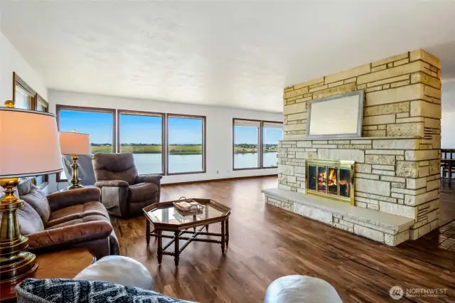 From this corner of the living room, you can see the amazing lake views, and to the right is the double French doors and hallway to the kitchen and dining room. There is another fireplace on the bottom floor.