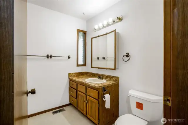 This is the main bathroom on the main floor. A shower and bathtub combo is behind the bathroom door.
