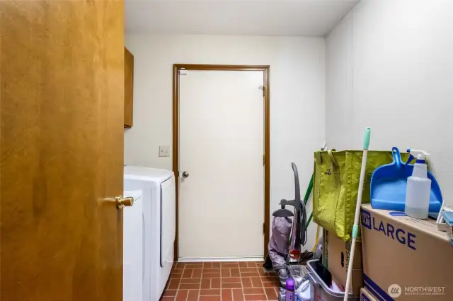 The utility/laundry room is on the main floor and comes with a washer and dryer. The far door leads to the two-car garage.