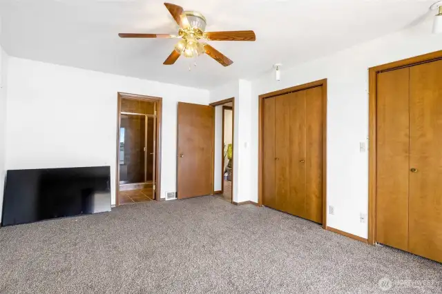 The primary bedroom also has two closets and a three-quarter bath with a large shower.