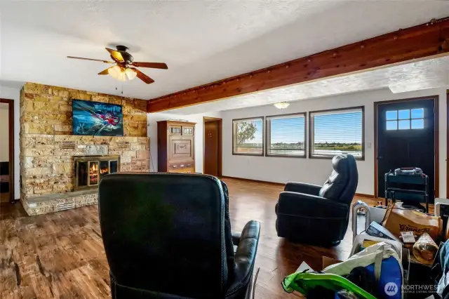 Behind the fireplace are two bedrooms with doors to the right and to the left of it, and there are connecting doors between the third and fourth bedrooms.  To the left of the photo is the kitchen, and behind you is the hall down to the fifth bedroom and garage.