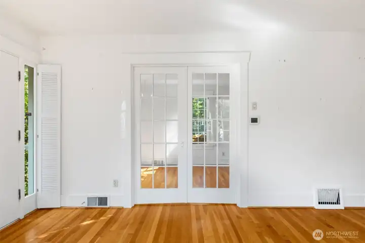 Glass, French doors, separate the living area...