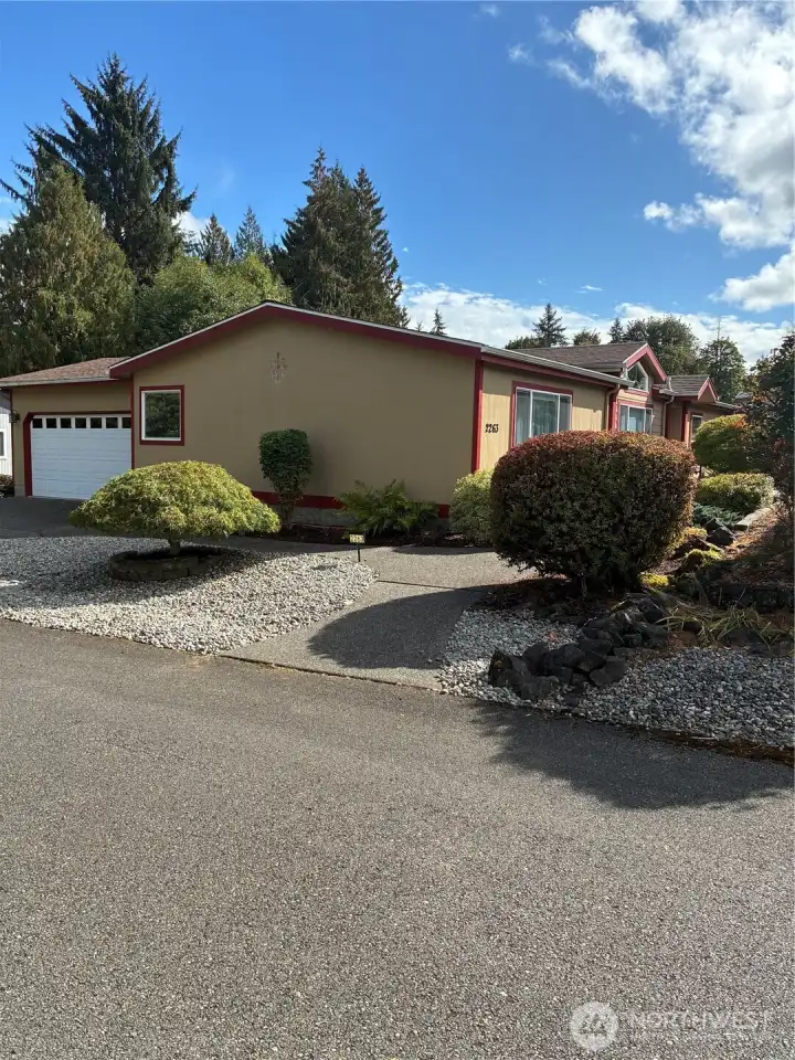 Double car attached garage, nice sidewalks, lovely shrubbery, low maintenance front yard.
