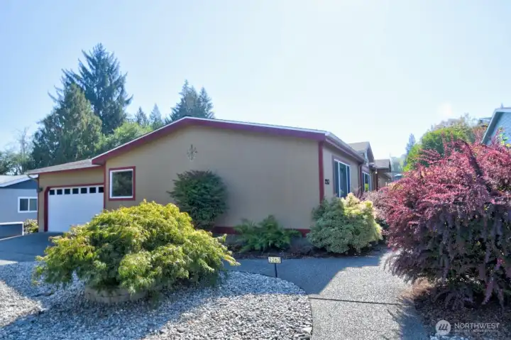 Double car attached garage, nice sidewalks, lovely shrubbery, low maintenance front yard.