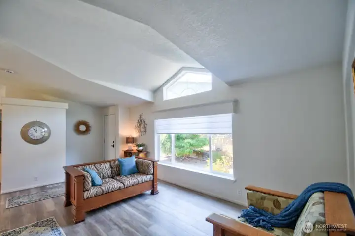 Entry to living room with grand picture window and transom window for lots of natural light.