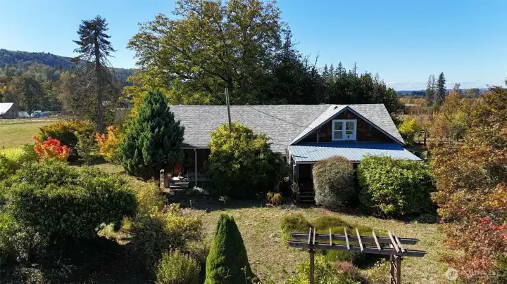 1940's Farmhouse with great basement/cellar, cool storage. New roof, huge paver patio and fruit and nut trees galore! Fresh bamboo flooring, ceramic tile kitchen floor, and more.