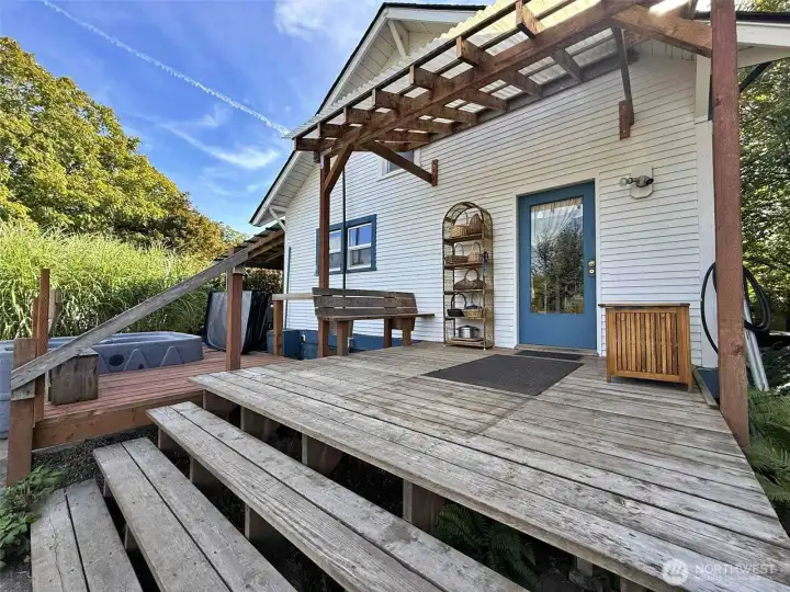 Cozy back door to the mud room with a 3/4 bath and laundry. Accesses the huge patio.