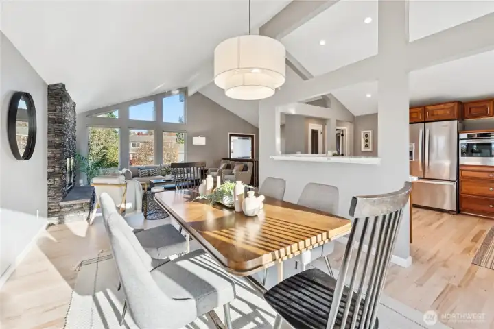 The Living room adjoins the Dining room and kitchen to form a great room w under vaulted beam ceilings and architecturally interesting framing opening views to all areas.