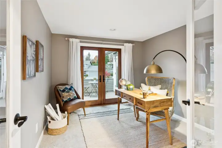 Across the hall, enter the office through double glass doors. The office also has wood French doors that open to the private deck shared with the primary bedroom that overlooks the front yard and northwest views.