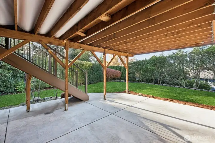 Waterproof patio has water channeling system installed within the framing and under the decking above.  There is also an outdoor shed adjacent to the patio.