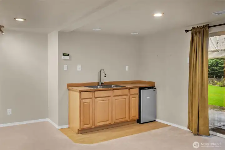 Living room in the lower level has a kitchenette. Mini fridge stays.