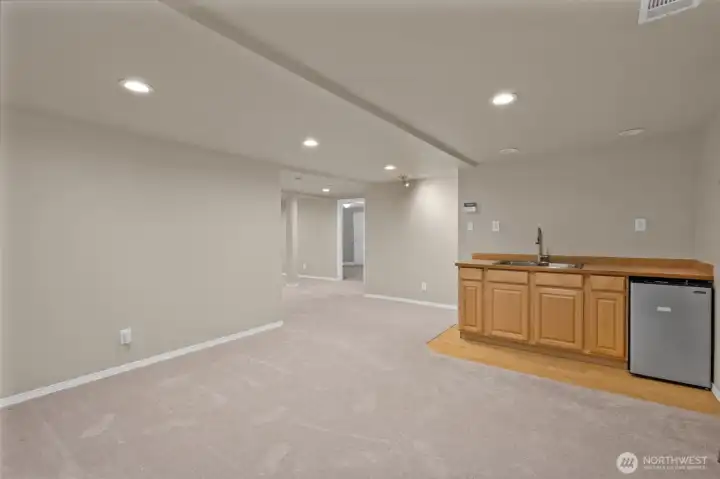 Living room in the lower level has a kitchenette. Mini fridge stays.