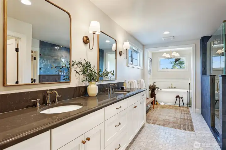 Spa-inspired primary bathroom includes radiant heated tile floors throughout, dual-sink vanity, free-standing tub, separate shower with gorgeous tile and a water closet. Enormous walk-in closet is accessed through the bathroom.