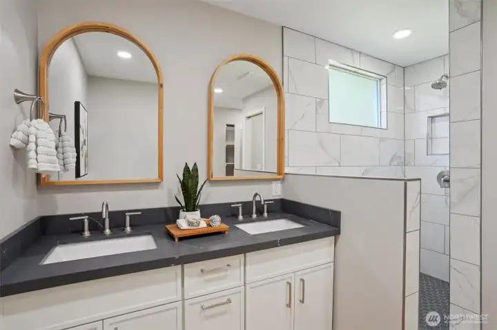 Primary bathroom with new tile shower, private toilet room, and walk in closet