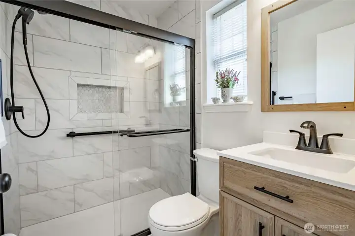 Primary Bathroom features newer walk-in tile shower.