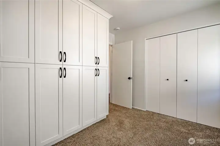 Bedroom 2 features original closets on right and to the left are all custom built-in closets.
