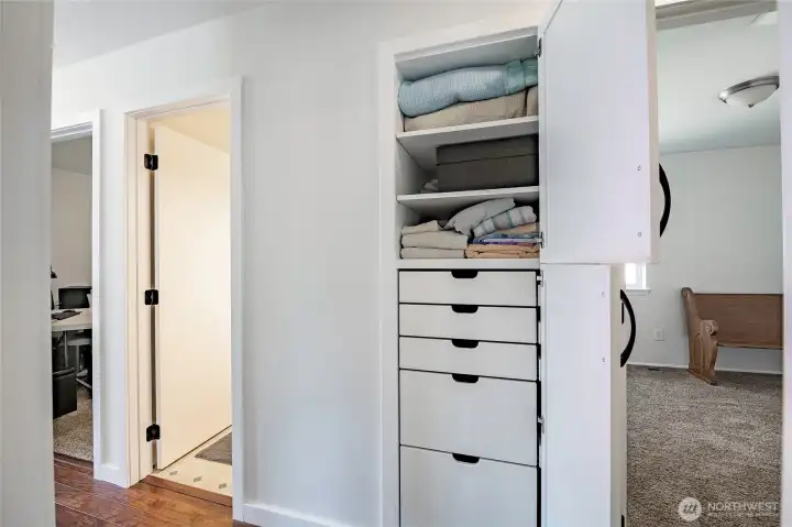 Hall closet showing drawers to maximize storage space.
