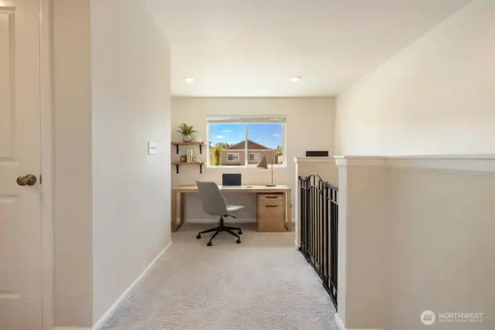 Upstairs off of Primary bedroom (Laundry to the left) looking at Loft (currently used as play room) (virtually staged as office)