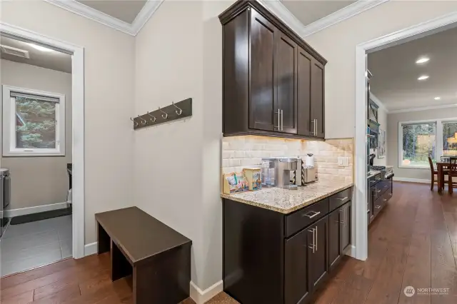 Nestled between the laundry room and the butler's kitchen, this convenient space is perfect for storing coats and boots, keeping things tidy when coming in from the garage.