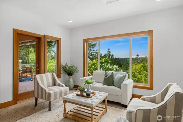 This room off of the kitchen makes a great family room. The large windows, skylight, and access to the deck bring in plenty of light.