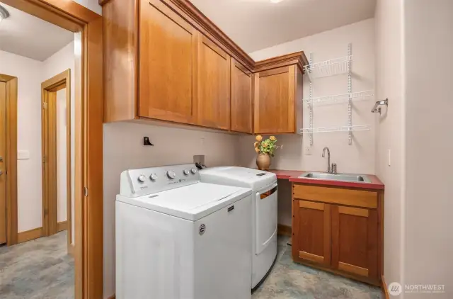 Laundry with plenty of storage is off the kitchen.