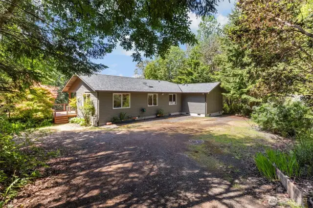 Entrance from the other side of the home.  You can just see the storage shed to the right through the trees.