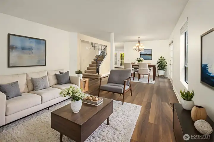 Large living room/dining room area with new interior paint and newer LVP flooring. This makes the perfect great room setting and includes french doors to the side deck and hot tub area. (Digitally staged)