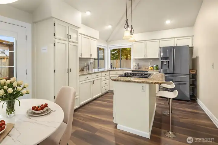 Vaulted ceilings in kitchen, eating area, and family room with southern exposure providing much needed natural light throughout the year (Digitally staged).
