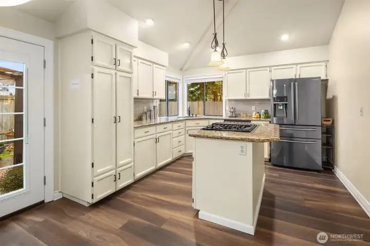 Newer appliances, granite countertops, multiple pantry cabinets, gas cooktop with vent, and dual oven. All appliances are included.