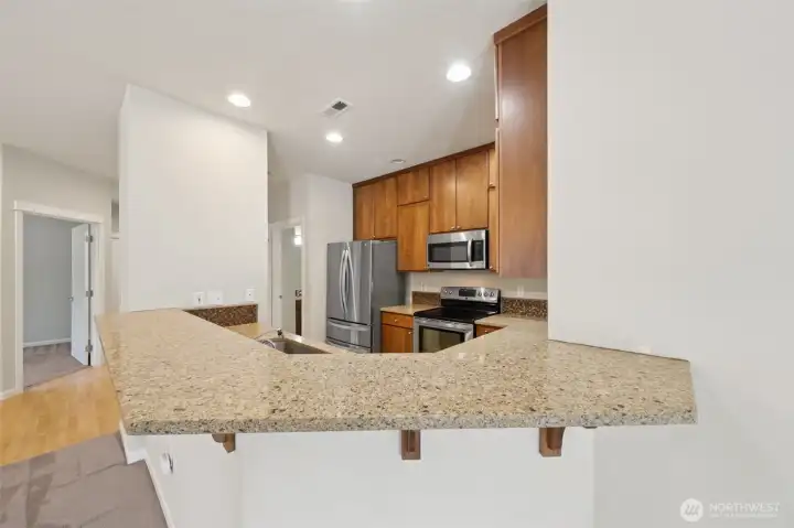 Updated Kitchen with Beautiful Countertops and Cupboards.