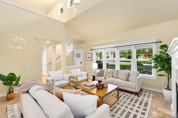 Formal living room w/ vaulted ceilings & fireplace