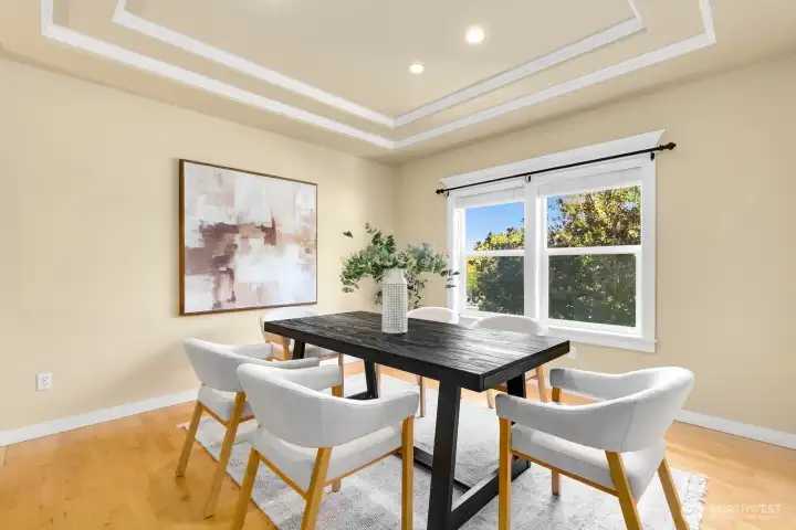 Formal dining room gazing out onto fully fenced yard, just shy of an acre