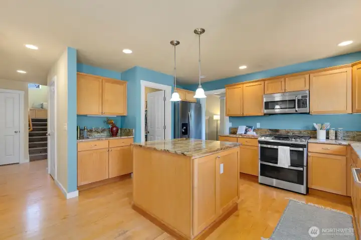 Open kitchen/ casual dining + den w/ fireplace