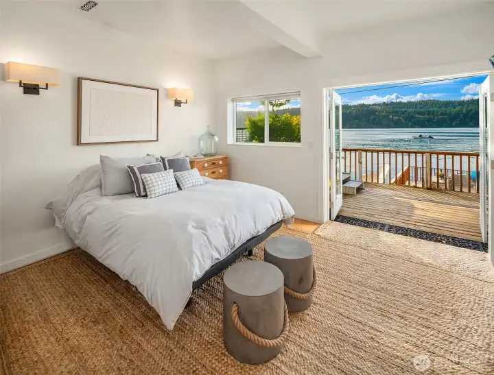 Large flex room downstairs currently used as sleeping quarters with bunk and queen bed with french doors to lower deck with hot tub