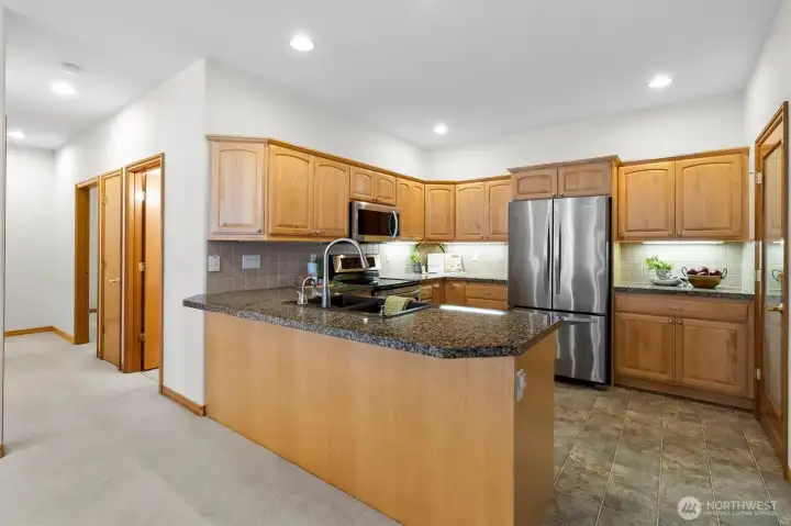 Efficient and spacious Kitchen with granite countertops and stainless steel appliances.