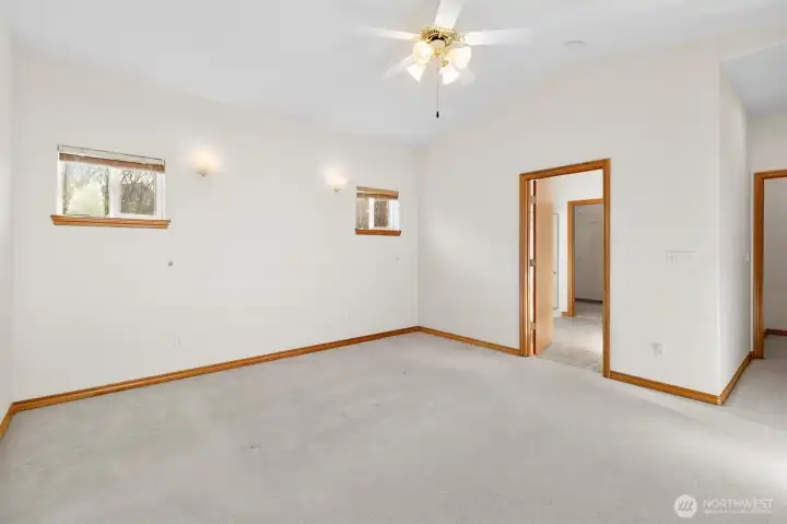 Large spacious primary with ceiling fan and natural light.