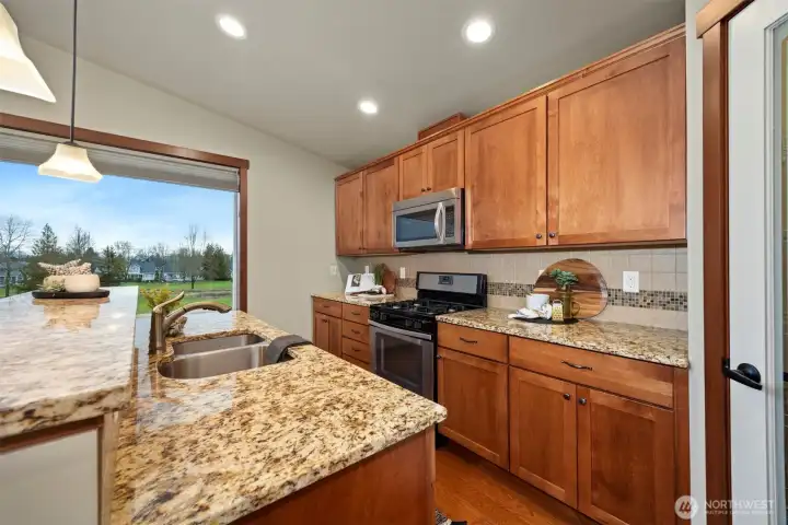 Enjoy the panoramic views of the woodland meadow from the kitchen, abundant counterspace & cabinet storage.