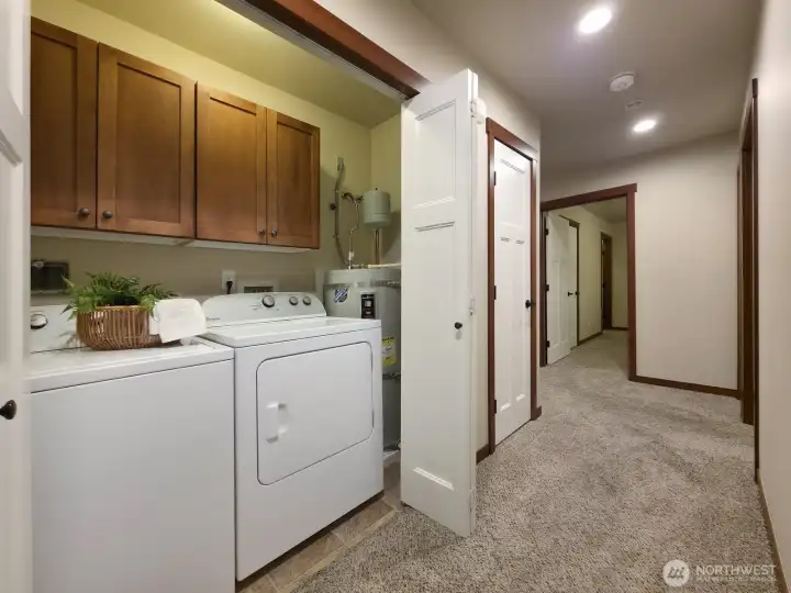 In-unit laundry closet, hallway leads to bedrooms & bathrooms.