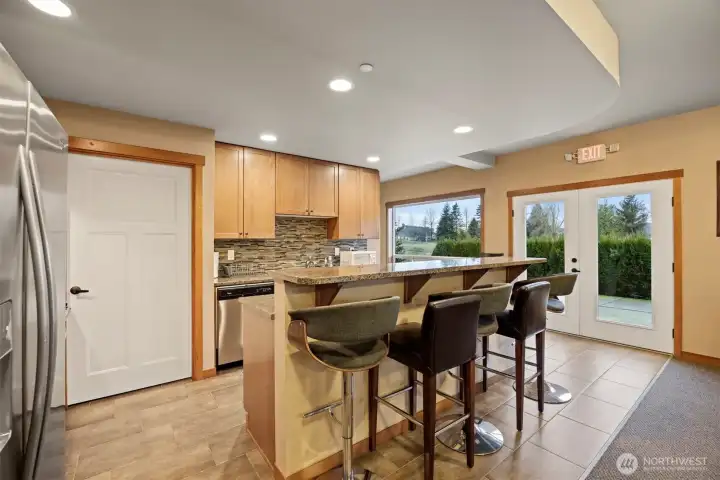 The community kitchen space is shared for the complex, with french doors that lead to the common patio area.