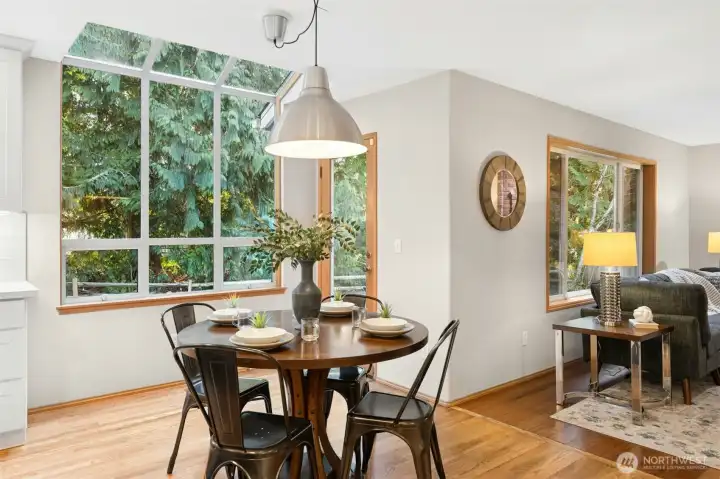 Informal breakfast nook with a bright garden window and a French door leading out to the backyard.