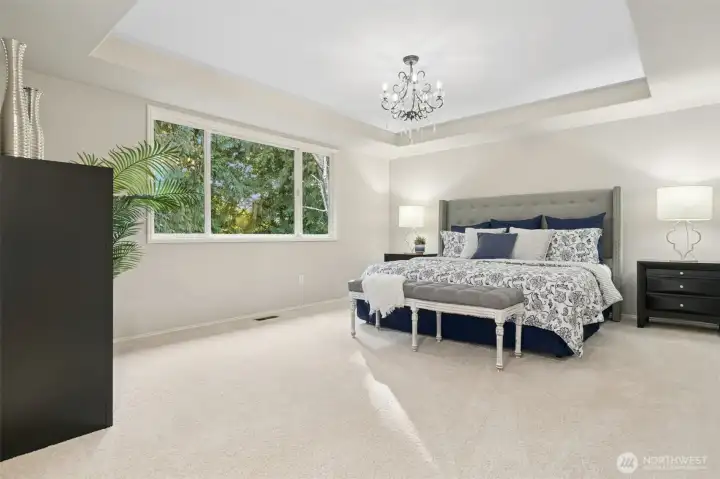 Luxurious primary suite with elegant recessed tray ceiling.