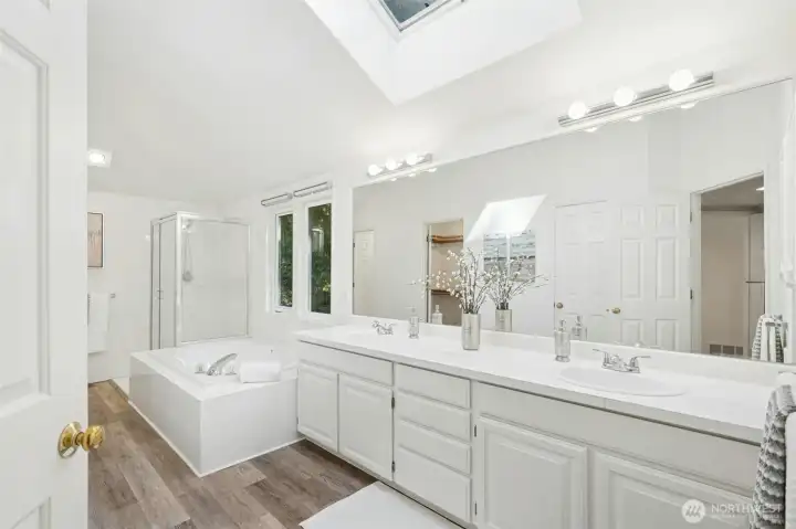 Bright and open bathroom with another light filling skylight above.