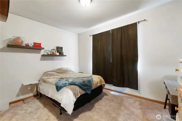 One of the 2 bedrooms on the main floor. Window looks out into the fenced yard. Also you have access to under the house from inside the closet.