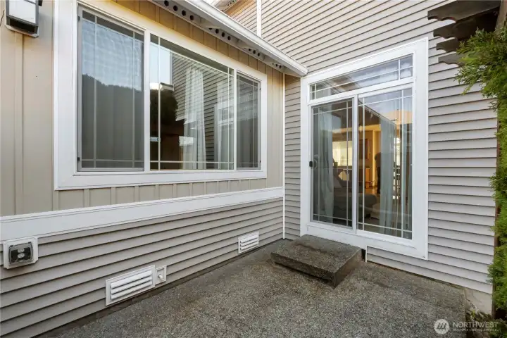Patio slider goes to the living room. The other window brings in light to the Primary bedroom.