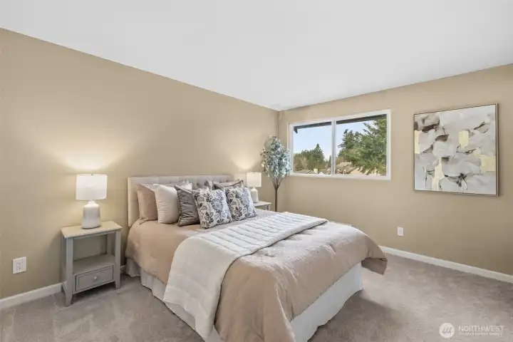 Primary bedroom featuring a walk-in closet with built-in storage and a private en-suite bath with shower.