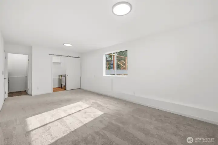 Large lower-level space perfect for a media room, playroom, or additional living area, with nearby laundry and a half bath for added convenience.