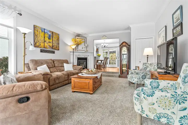 Living room off entry with tons of natural light and a cozy gas FP open to the dining room