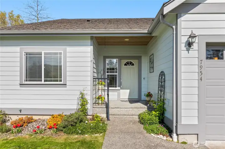 Covered front entry with welcoming porch and loads of curb appeal.